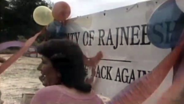 Putting up the sign 'City of Rajneesh' (still)