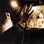 Osho driven past Buddha statue