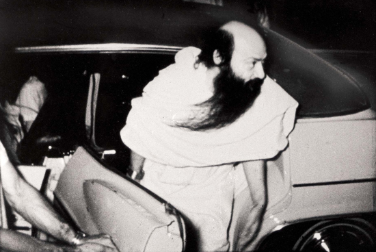 Osho stepping out of car