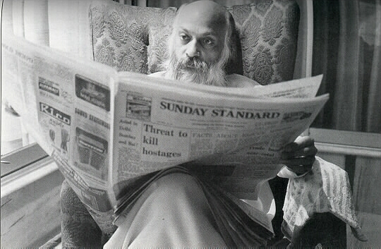 Osho reading  a newspaper
