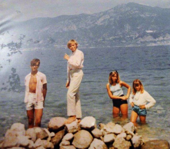 Pritam, on top of rocks, with brother and sisters at Lake Garda