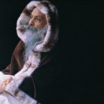 Osho wearing a hood