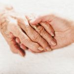 Old and young holding hands