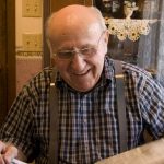 Old man reading newspaper