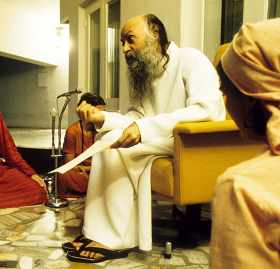 Osho in darshan giving initiation