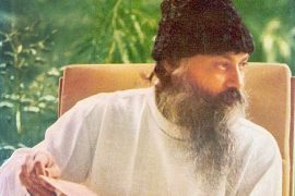 Osho with book in garden