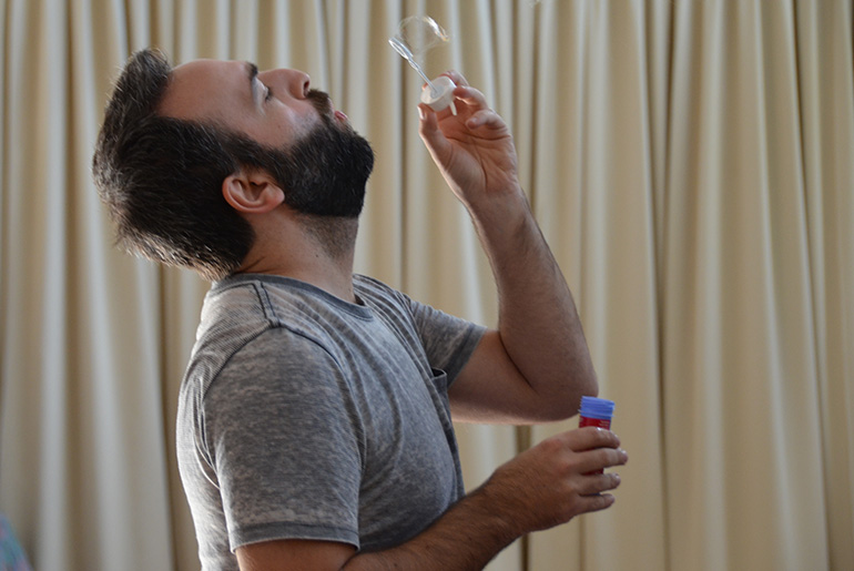 man playing with soap bubbles