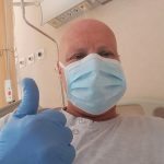 Nadama in hospital with a thums up