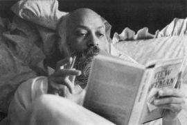 Osho reading in bed