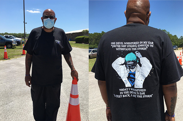 Black man wearing T-shirt with slogan
