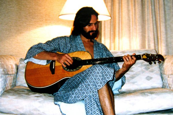 Strumming my guitar in a Singapore hotel, 2000