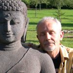Meditator with Buddha statue