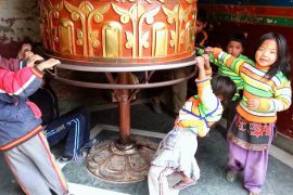 children playing on prayer drum