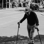 old man walking on a stick