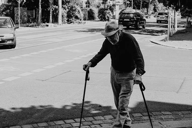 old man walking on a stick