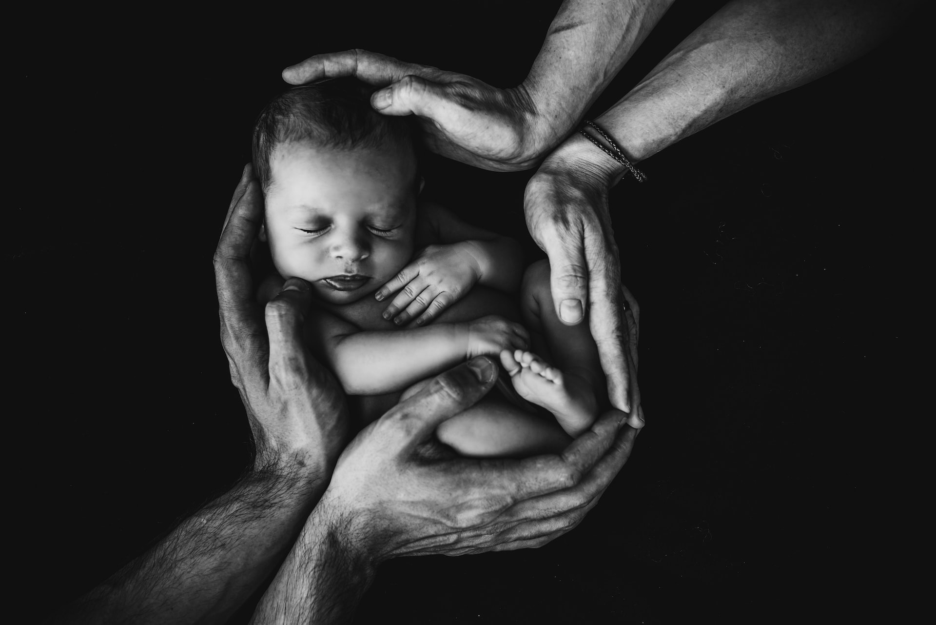 baby held by hands