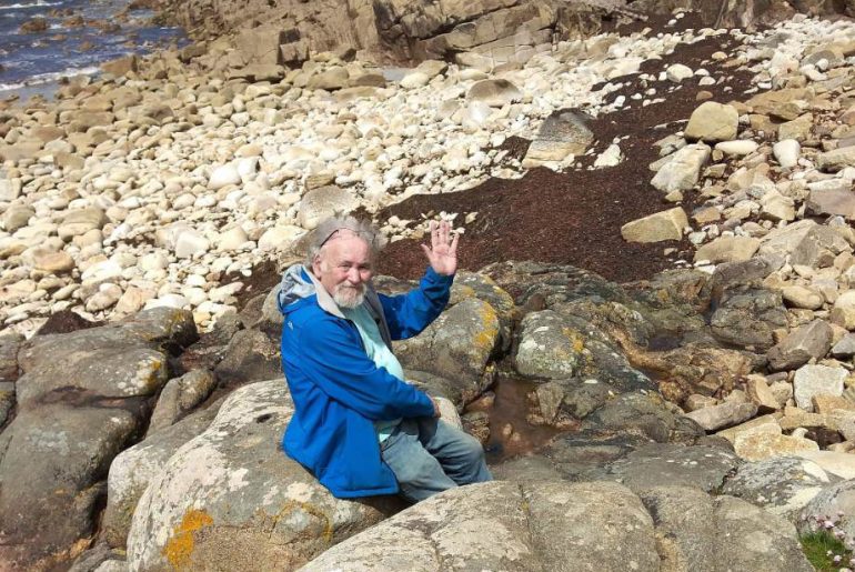 Nirdosh waving from the rocks