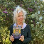 Deva Padma holding The Sacred She deck