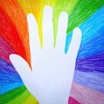 Hand on rainbow colours