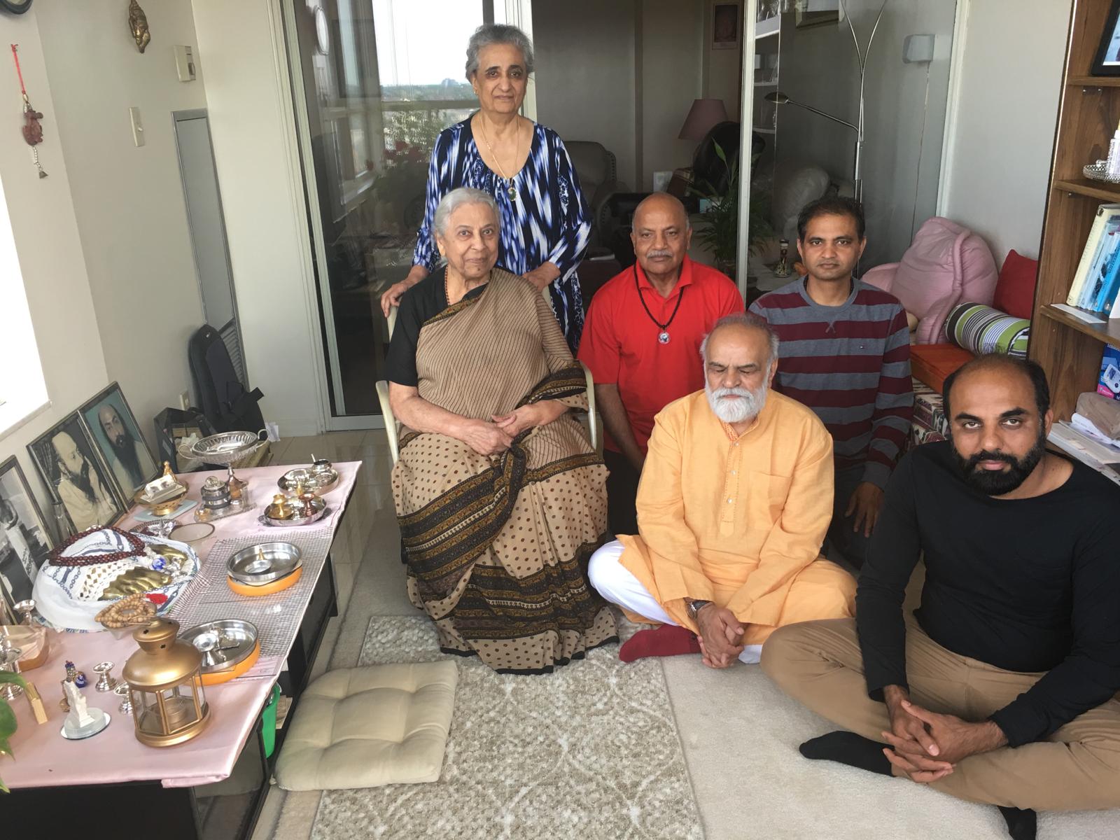Priya, Keerti and friends meditating with charan kamal