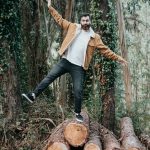 Man balancing on log