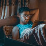man reading in bed