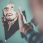 man looking in mirror