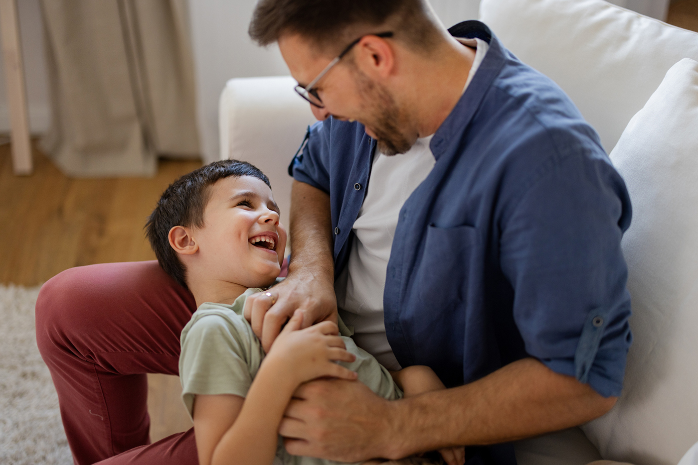 Father tickling son