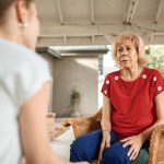 Two women sitting across from each other