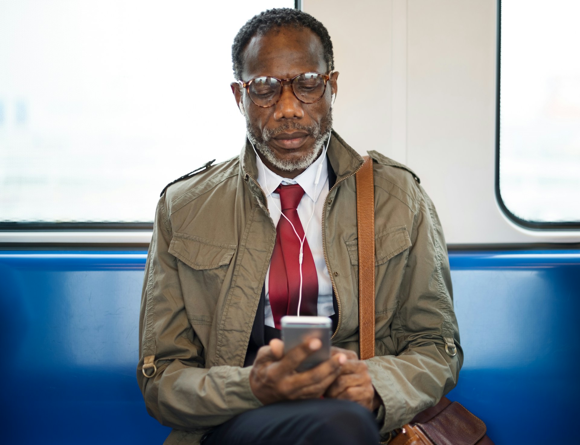 Man in train with cellphone